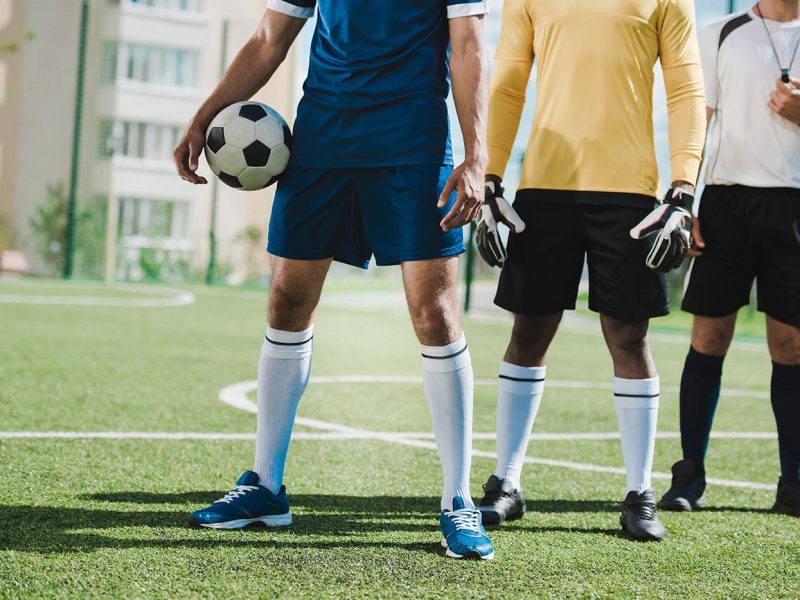 partial-view-of-soccer-players-and-referee-standin-2021-08-31-14-49-48-utc