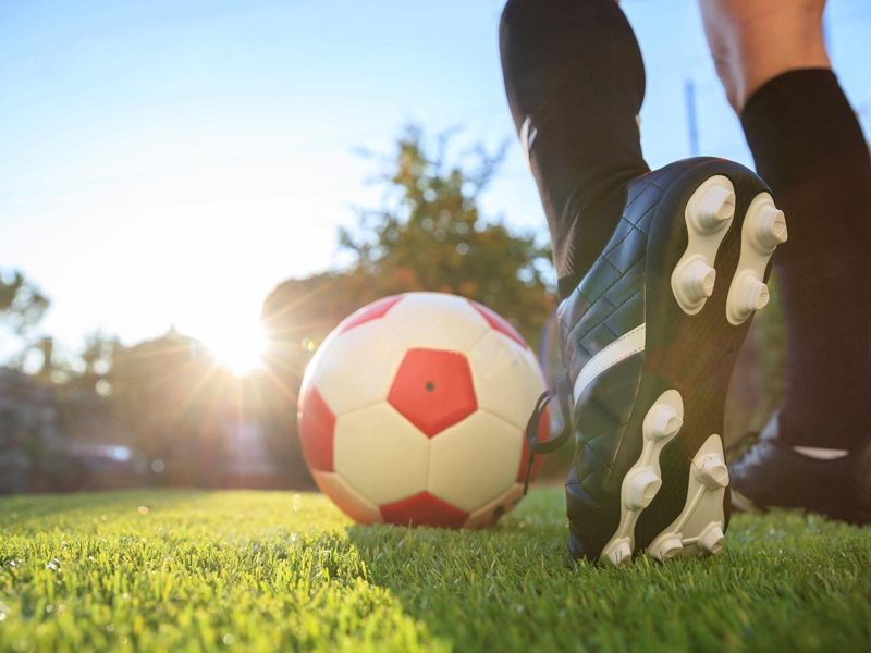 woman-and-a-soccer-ball-on-the-grass-2021-08-26-16-34-02-utc